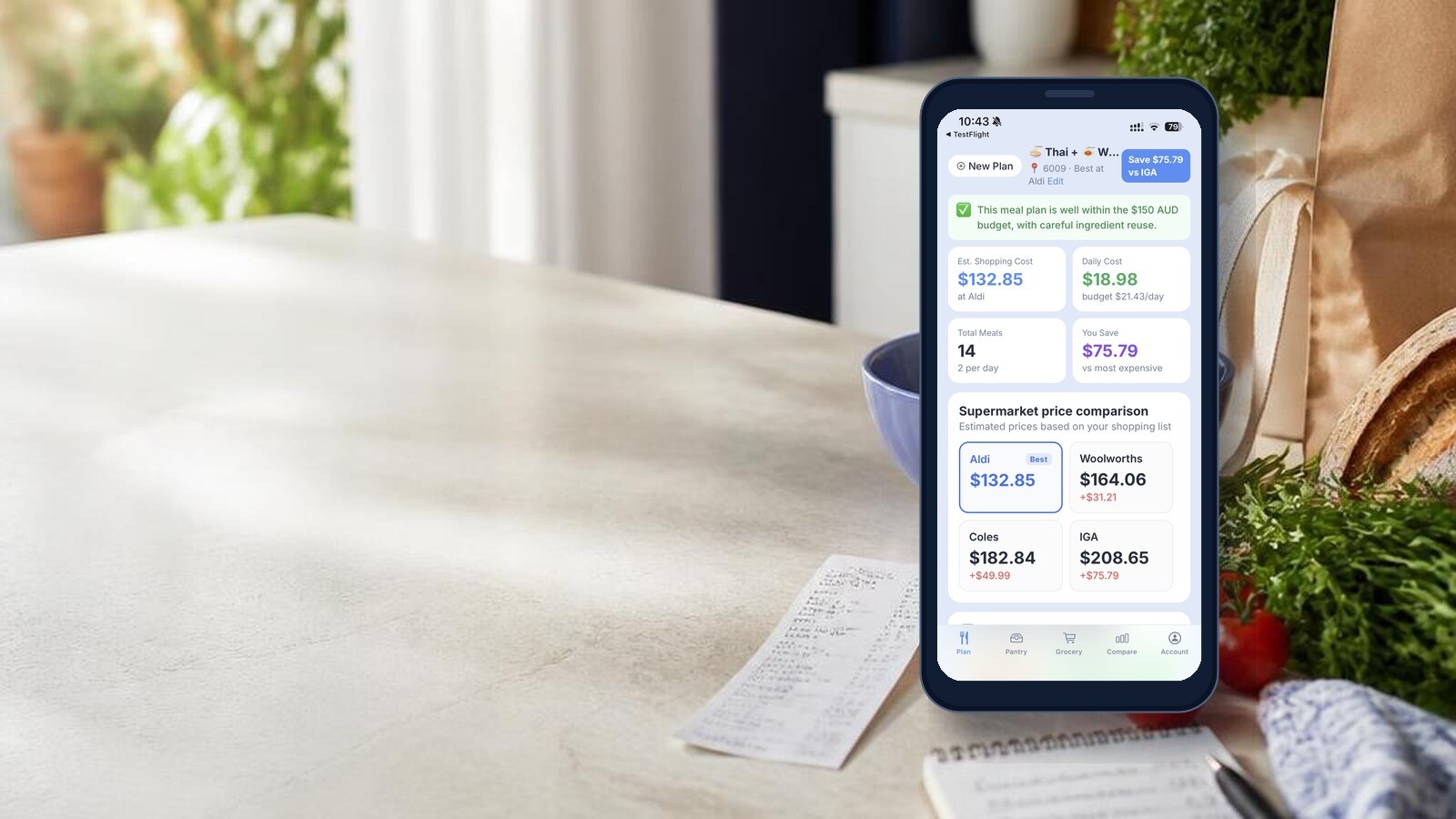 MealPantry supermarket price comparison on a phone beside a grocery bench and weekly receipt